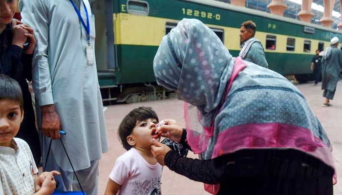 Japanese Prime Minister Fumio Kishida is concerned about the dangerous decline in the country's population A female volunteer is administering polio drops to a girl at Lahore Railway Station.