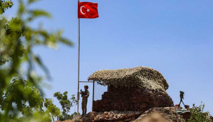 An armed group attacked a Turkish military base with rockets A military official stands at a checkpoint of the Zilkan base, file photo