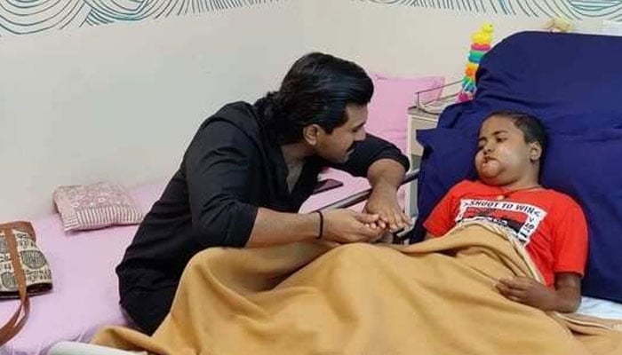 Actor Ram Charan meets a child suffering from cancer Actor Ram Charan meets a child suffering from cancer