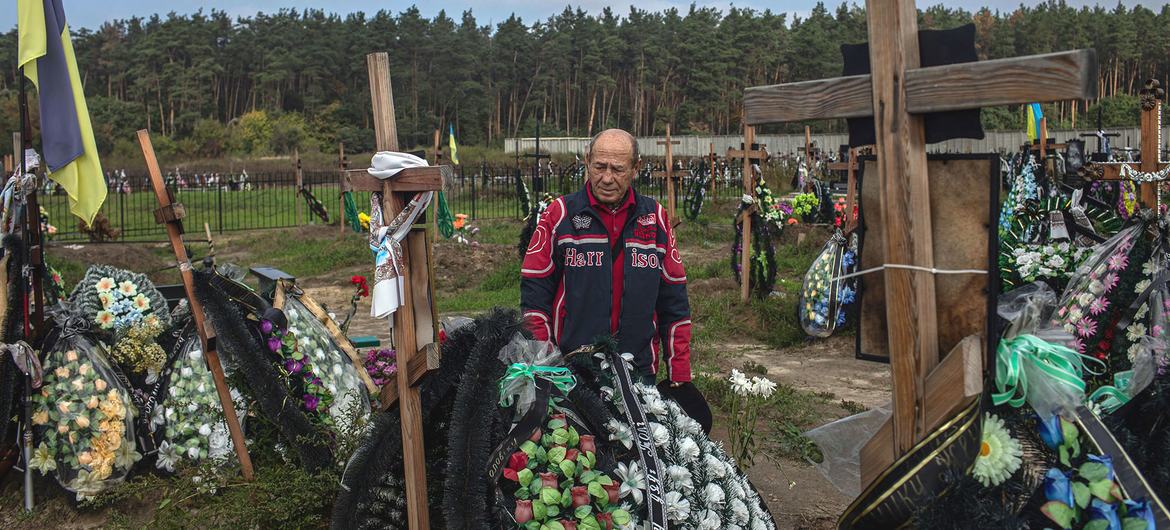 A man mourns his deceased best friend at a cemetery in Bucha, Ukraine. A man mourns his deceased best friend at a cemetery in Bucha, Ukraine.