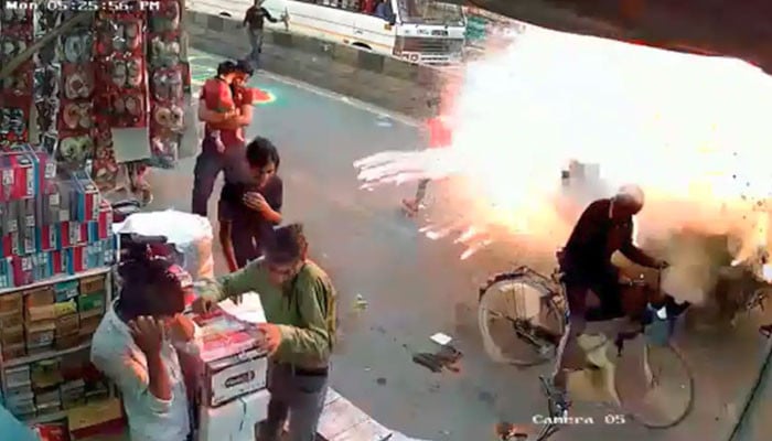 A firecracker burning in a rickshaw full of firecrackers, India, Agra