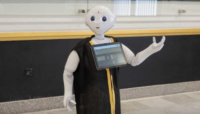 Robots are deployed to welcome visitors in the factory that manufactures the Kaaba cover