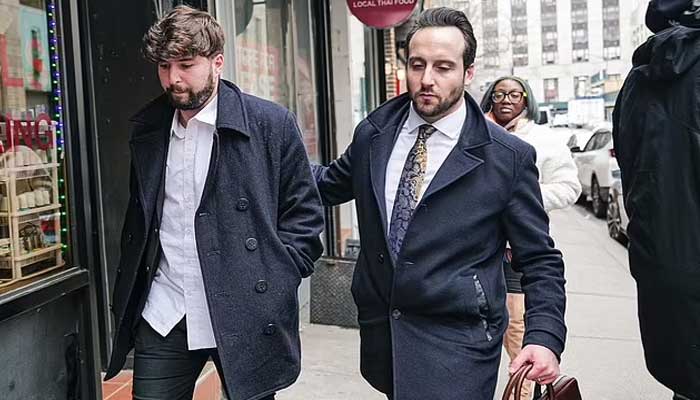 Israeli consulate official accused of attempted murder Jonathan Maimon (left) walks out of court with a man after being granted bail.