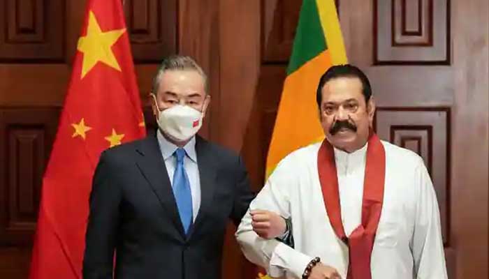 China came to the aid of Sri Lanka in difficult times, willing to reschedule loans Colombo, January 2022: Chinese Foreign Minister Weng Yi stands arm in arm with Sri Lankan Prime Minister Rajapaksa.