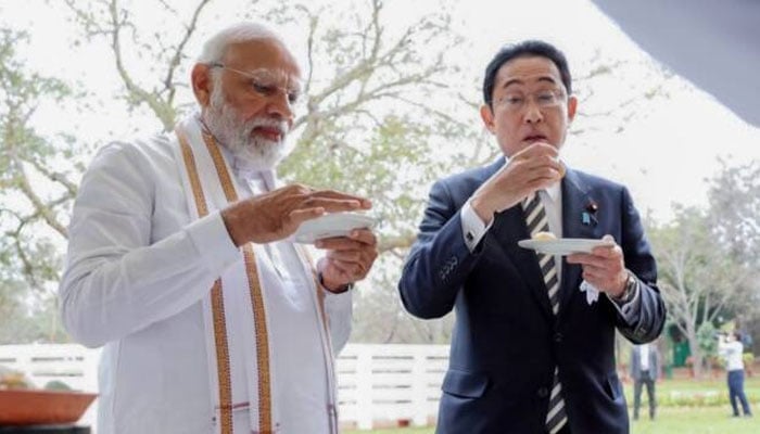 What is being fed to the Japanese Prime Minister in India? Photo courtesy of Indian Media