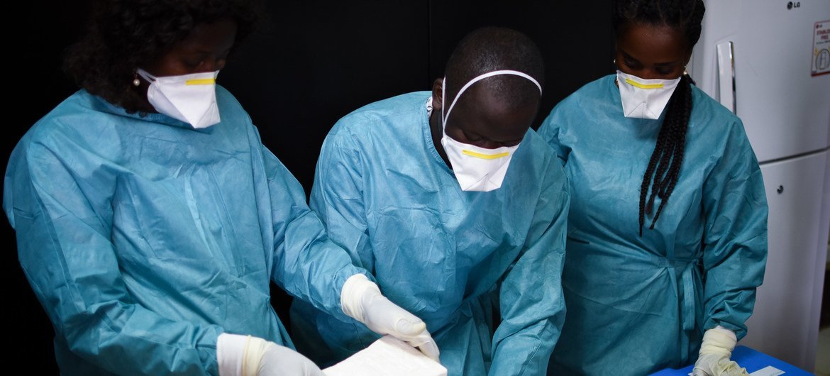 Experts examine a shipment of cocaine seized in Guinea-Bissau. Experts examine a shipment of cocaine seized in Guinea-Bissau.