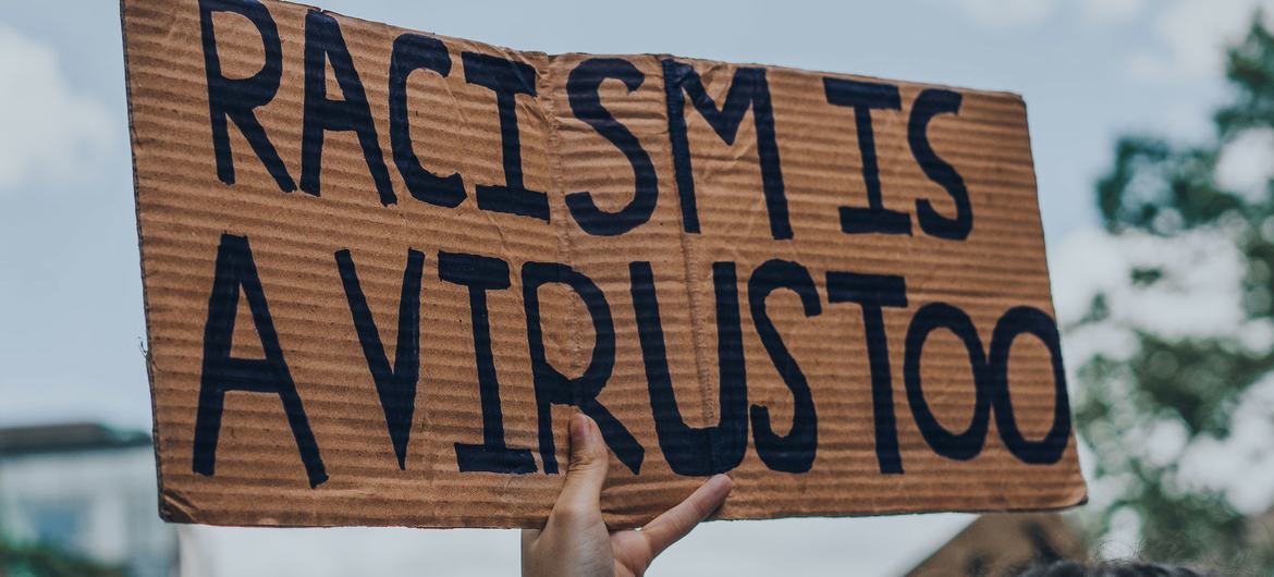 Racism is a Virus sign  at a Black Lives Matter protest in Montreal, Canada.