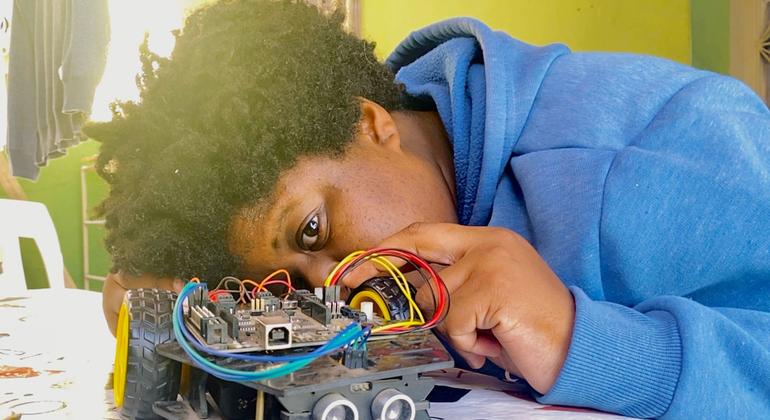 A Brazilian scientist working on a robot in Rio de Janeiro