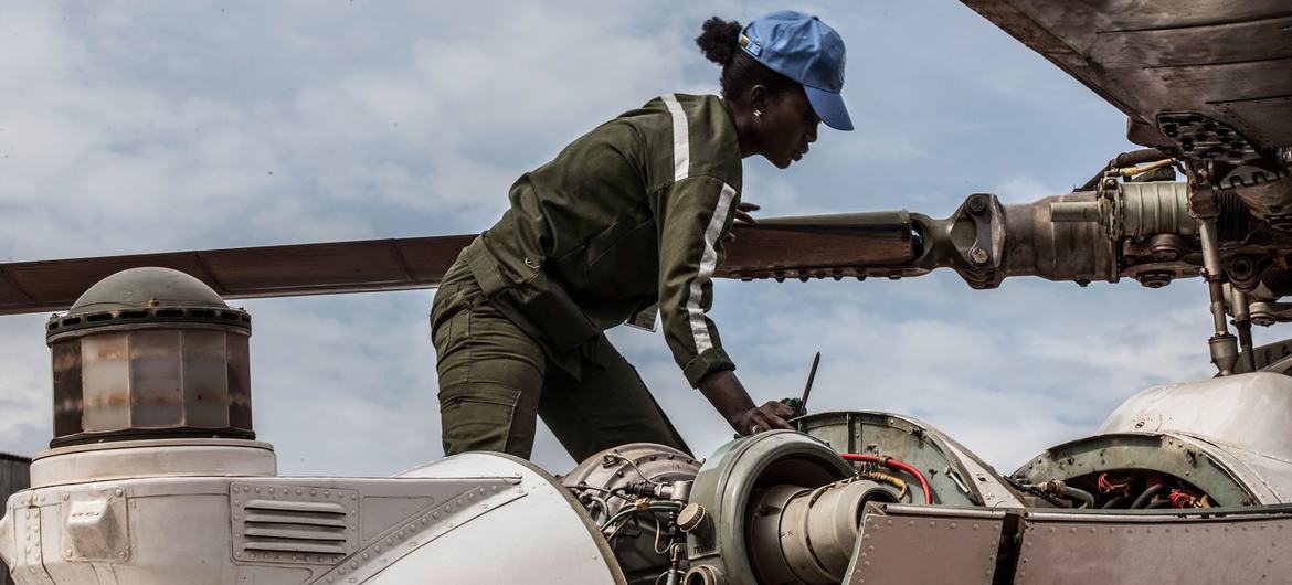 A Senegalese woman peacekeeper works on a helicopter deployed to MINUSCA, the UN peacekeeping mission in the Central African Republic. A Senegalese woman peacekeeper works on a helicopter deployed to MINUSCA, the UN peacekeeping mission in the Central African Republic.