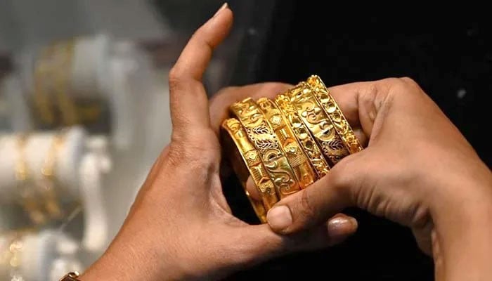 An increase in the price of one tola of gold by Rs.5600