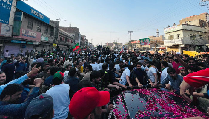 Imran Khan riding in a bulletproof vehicle