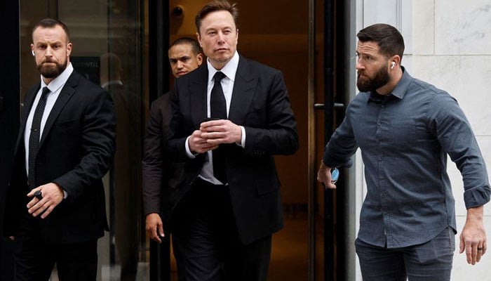 Why does Elon Musk always have two bodyguards with him?