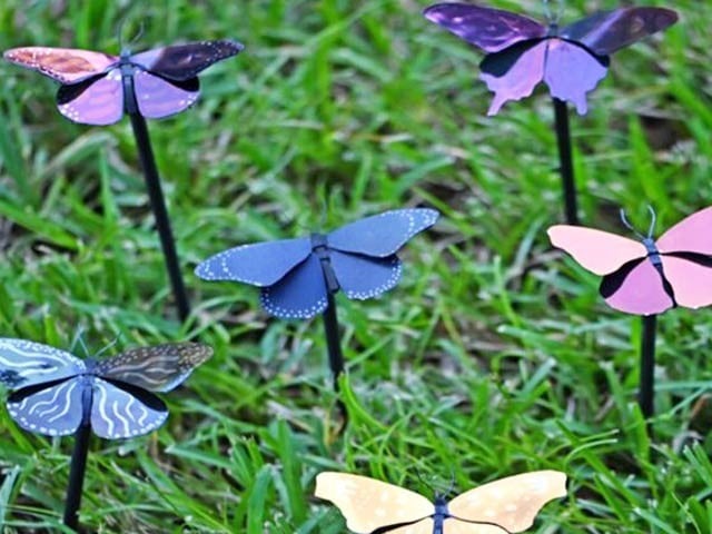 Plasmonic paint is applied to metal butterflies to reveal different colors.  Photo: Courtesy of University of Florida 