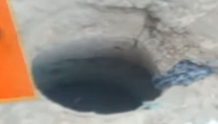 In Orangi Town, a man and a woman riding a motorcycle fell into the gutter