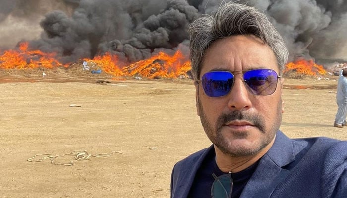 Why did Adnan Siddiqui take a picture with burning drugs?