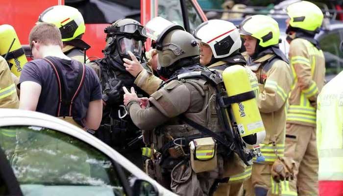 Several police officers and firefighters were injured in the explosion in the building Firefighters stand outside the building after the explosion.