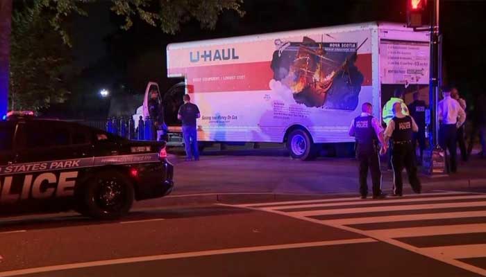 Security personnel stand around the truck that crashed into the White House barrier.