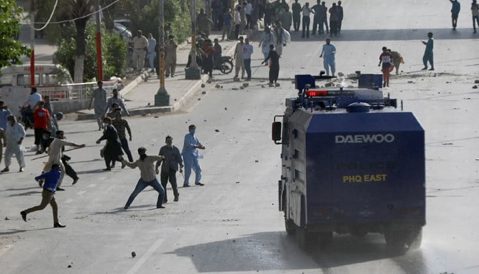 Police shelling to disperse protesters on Rashid Minhas Road