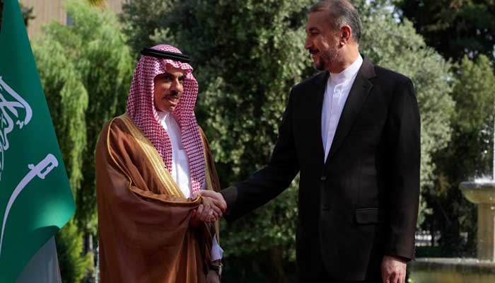 Saudi Foreign Minister shaking hands with his Iranian counterpart.