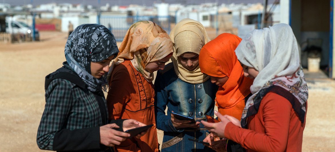 Adolescent girls use cellphones and tablets in the Za’atari camp for Syrian refugees (file). Adolescent girls use cellphones and tablets in the Za’atari camp for Syrian refugees (file).