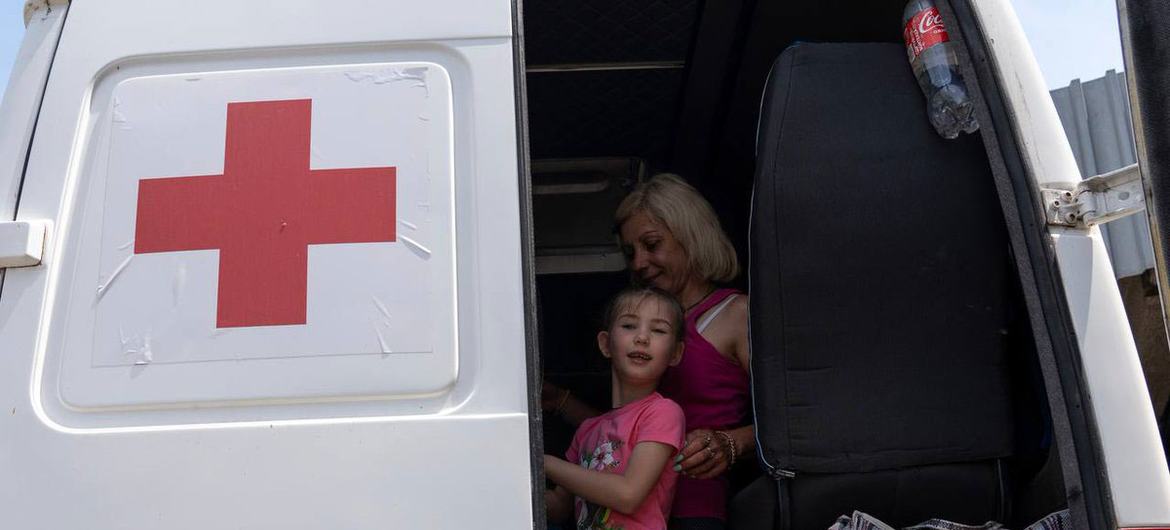 A family receives medical treatment in Odesa after being resuced in Kherson following the destruction of the Kakhovka dam.