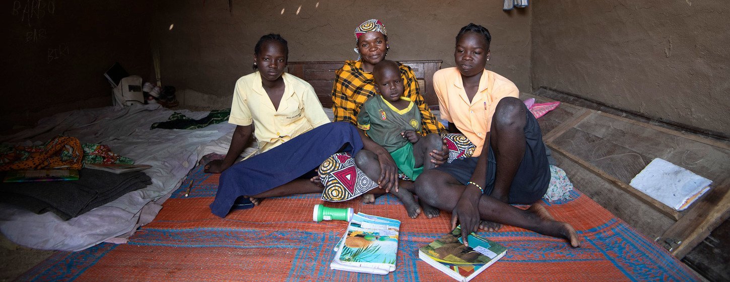 Fleeing her village in northern Cameroon after armed insurgents seized control, Mamma Hamidou (centre) received income-generating funding from UNDP and, with her earnings, built a small house and sends her children to school. (February 2019) Fleeing her village in northern Cameroon after armed insurgents seized control, Mamma Hamidou (centre) received income-generating funding from UNDP and, with her earnings, built a small house and sends her children to school. (February 2019)