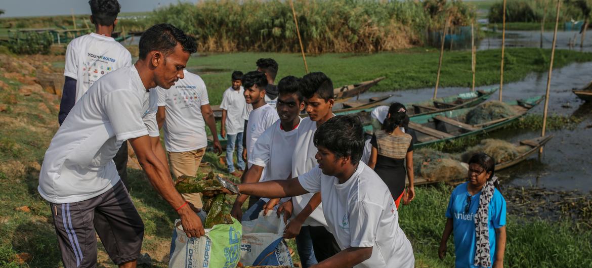 Young people collecting plastic bottles, cans and solid waste from Chilika wetland, eastern India.. Young people collecting plastic bottles, cans and solid waste from Chilika wetland, eastern India..