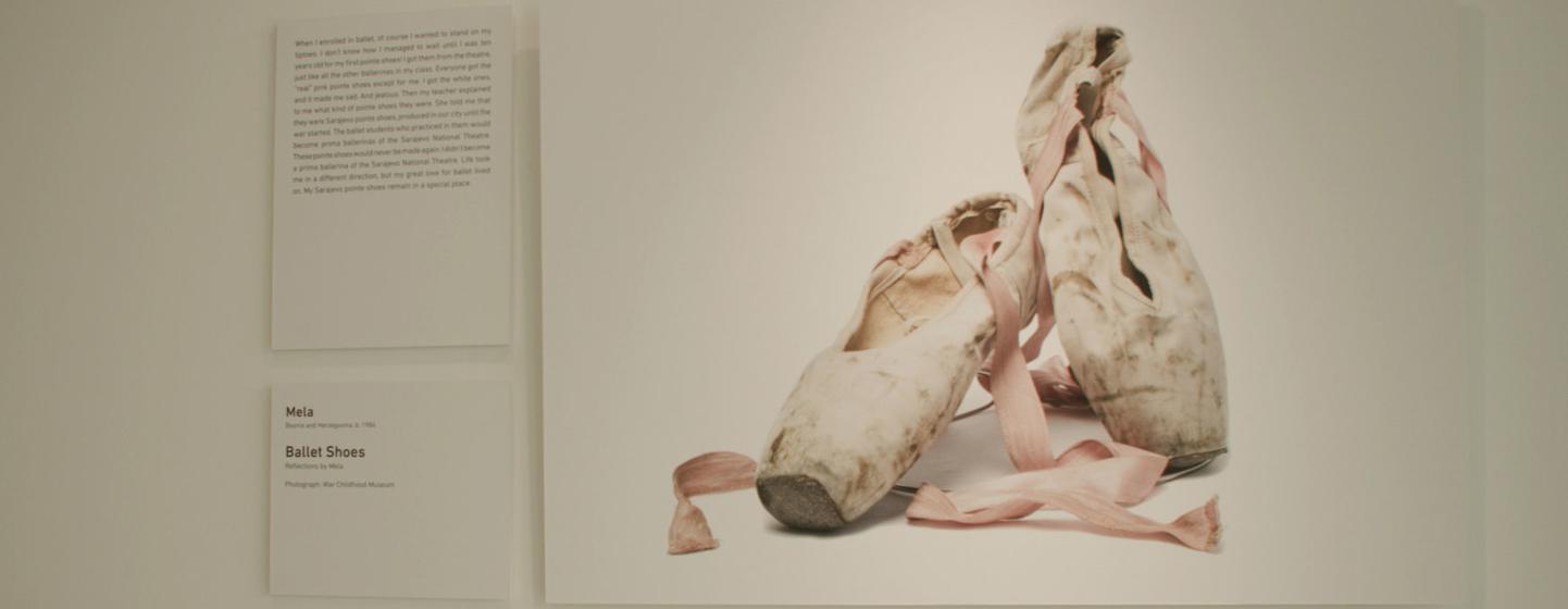 A display at the Stories of Survival and Remembrance exhibit at UN Headquarters depicting pointe shoes that belonged to Mela, who lived through the Bosnian War.