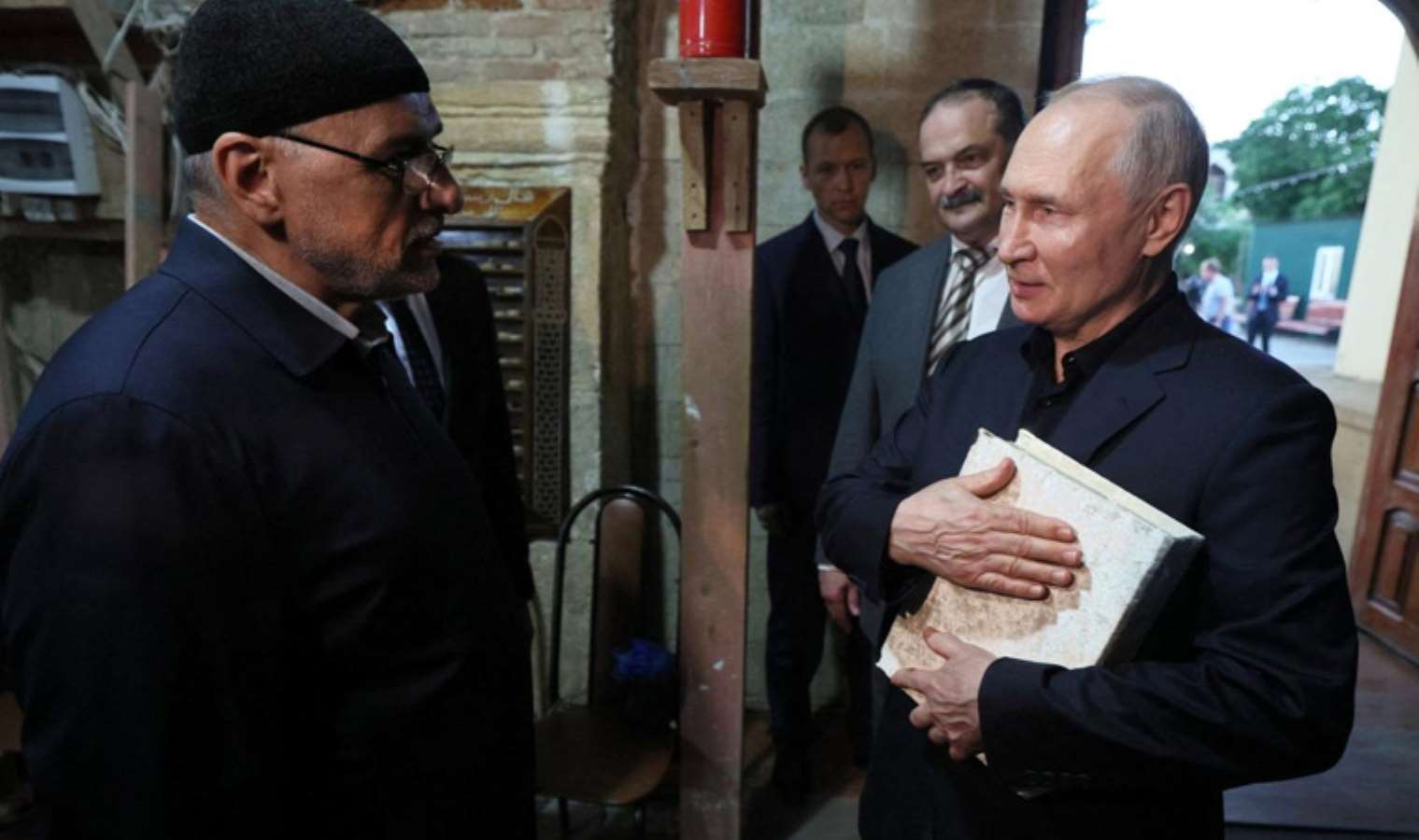 Russian President Putin hugged the Quran to his chest