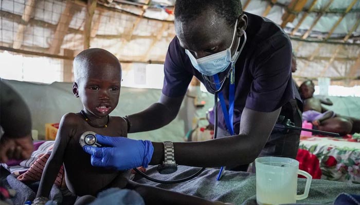 The entire country could suffer from hunger and disease because of the clashes, the United Nations A sick child is being treated in a tent-like hospital due to malnutrition.