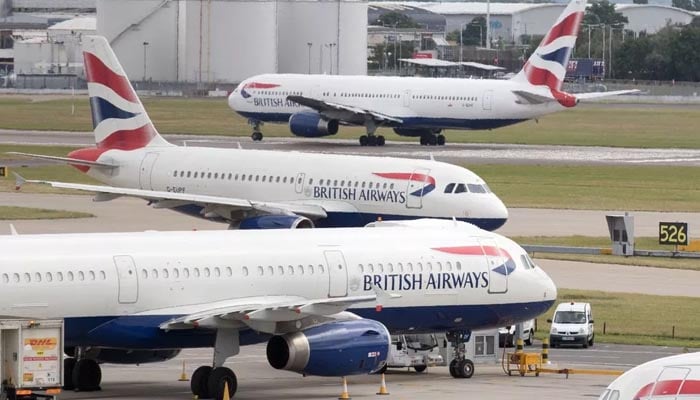Passenger planes are parked at Heathrow Airport.
