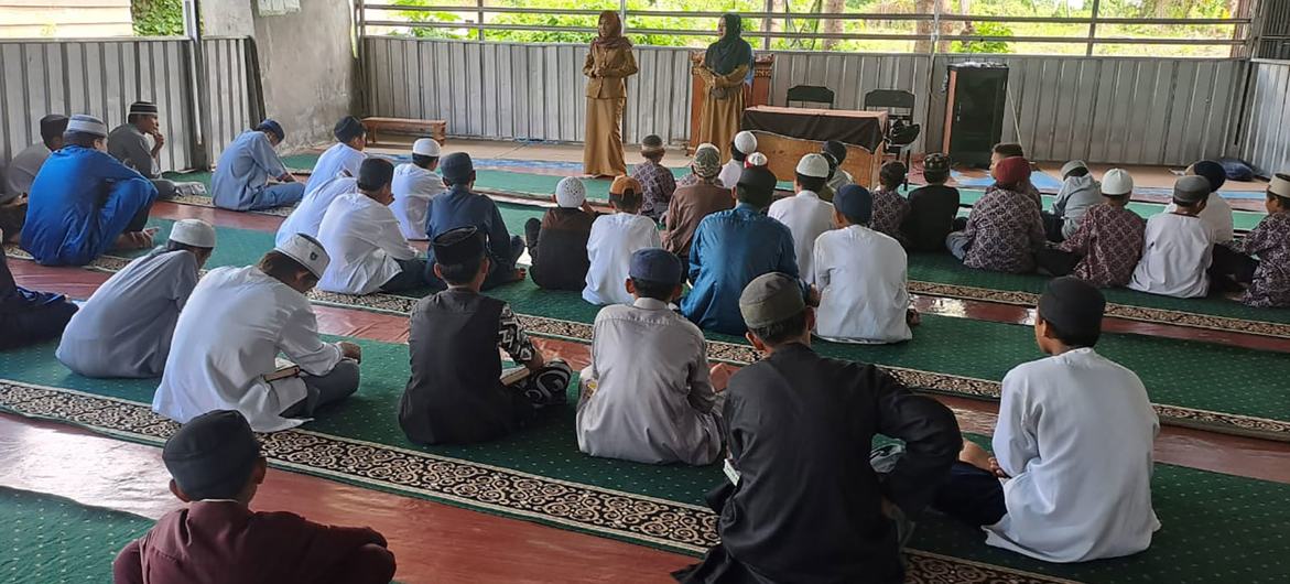 Men at religious community centre discuss gender-based and domestic violence. 