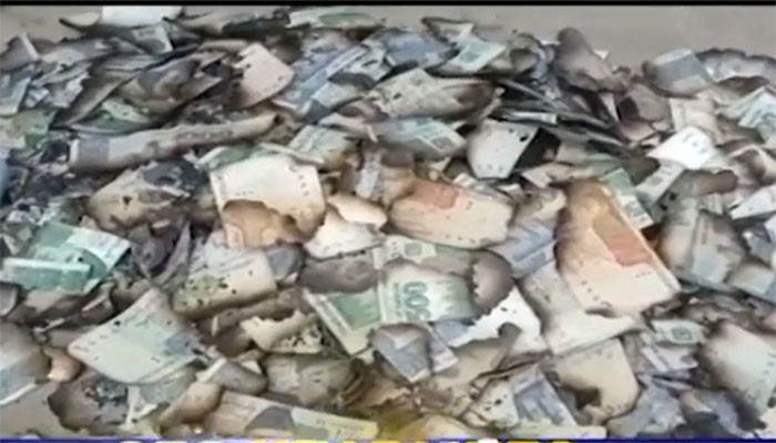 Burnt currency notes recovered from Gakhar Mandi graveyard