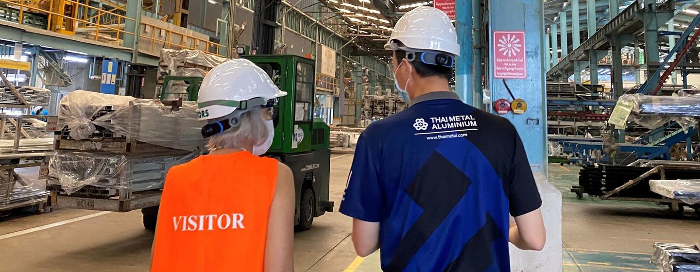 UN Resident Coordinator Gita Sabharwal (left) visits an aluminum-processing factory.