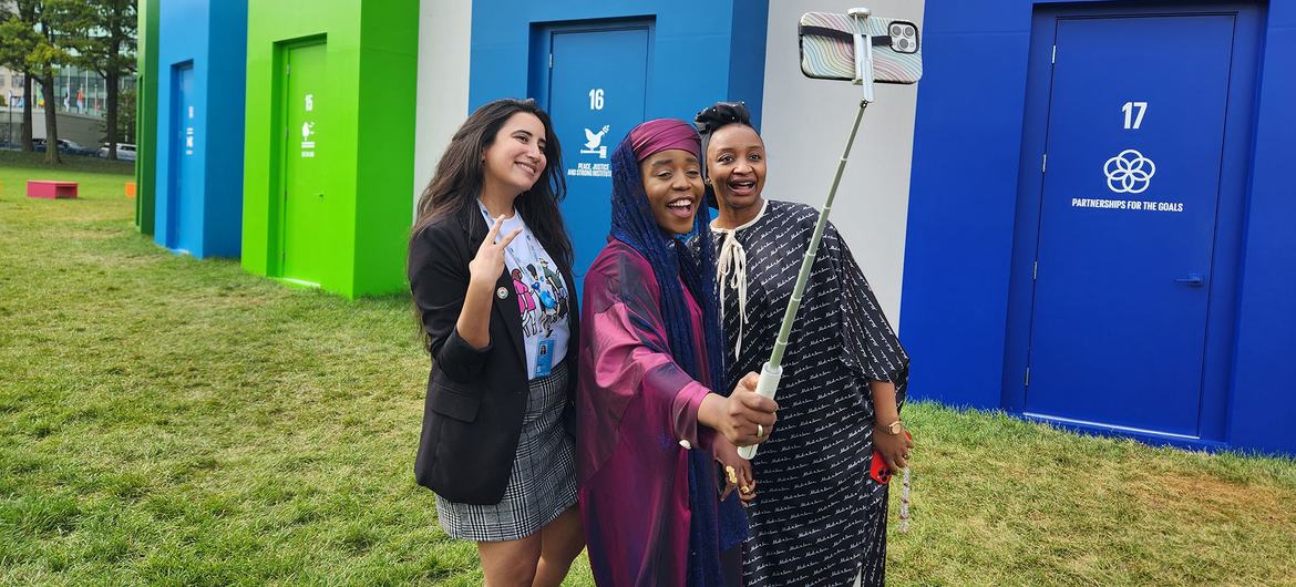 Poet Alhaníslam and actor Rahama Sadau pose for a photo with a fan.