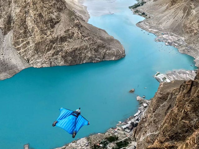 Norwegian wingsuit pilots jump from a cliff near Attabad Lake