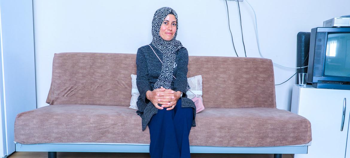 Emel sits in her living room. Emel sits in her living room.