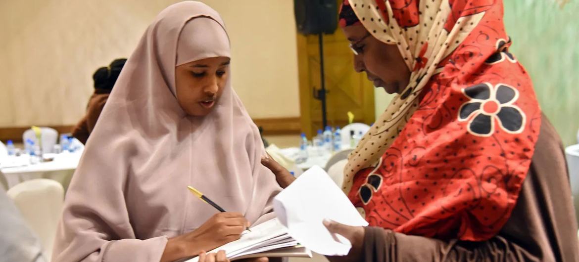 Two women seeking to become part of the political process in Kenya exchange ideas.