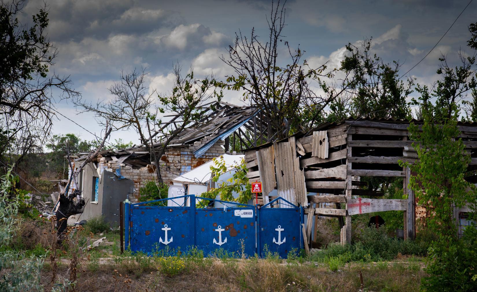 A landmine warning sign behind a fence of a destroyed house in Posad-Pokrovske in the Kherson region of Ukraine. A landmine warning sign behind a fence of a destroyed house in Posad-Pokrovske in the Kherson region of Ukraine.