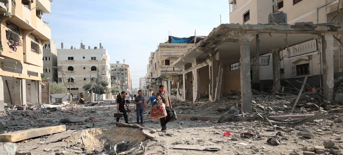 Men walk through the destroyed streets of Gaza.