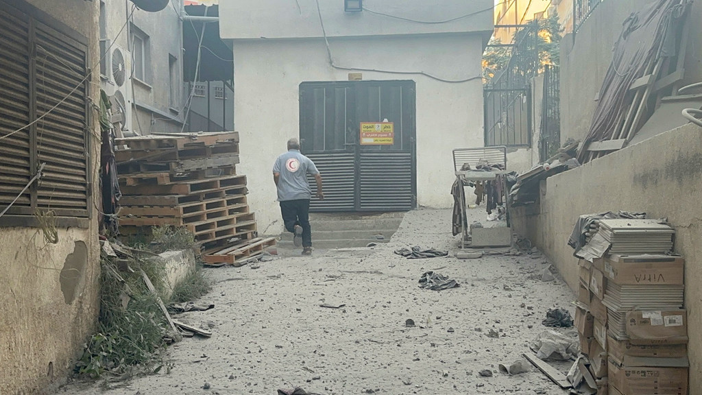 A Red Crescent worker at the Al Quds hospital in Gaza flees bombing. (file) A Red Crescent worker at the Al Quds hospital in Gaza flees bombing. (file)