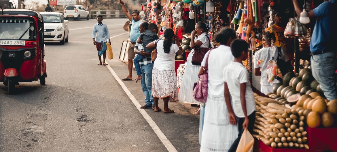 People shop at a market outside Sri Lanka