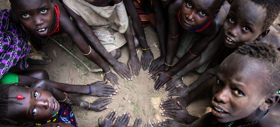 Children make a shape with their hands in the south Omo district of southern Ethiopia.