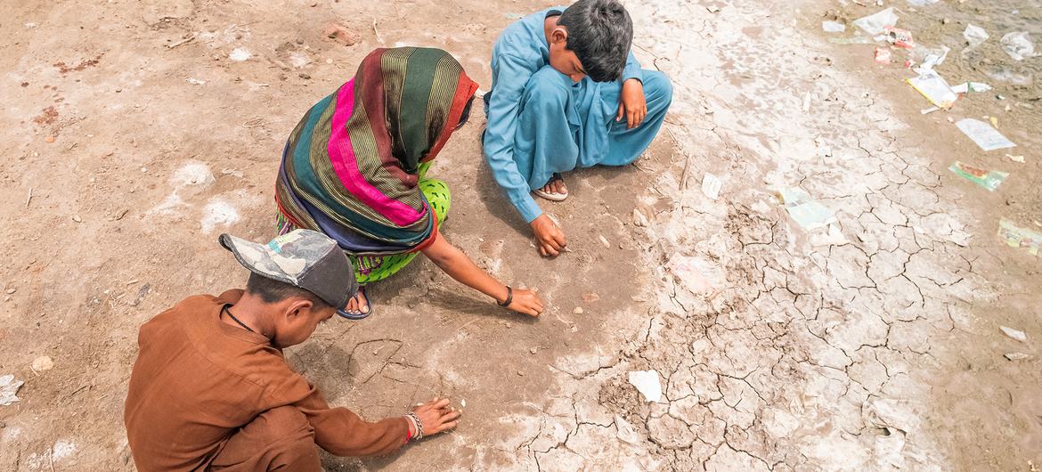 Children play on parched land in southern Pakistan.