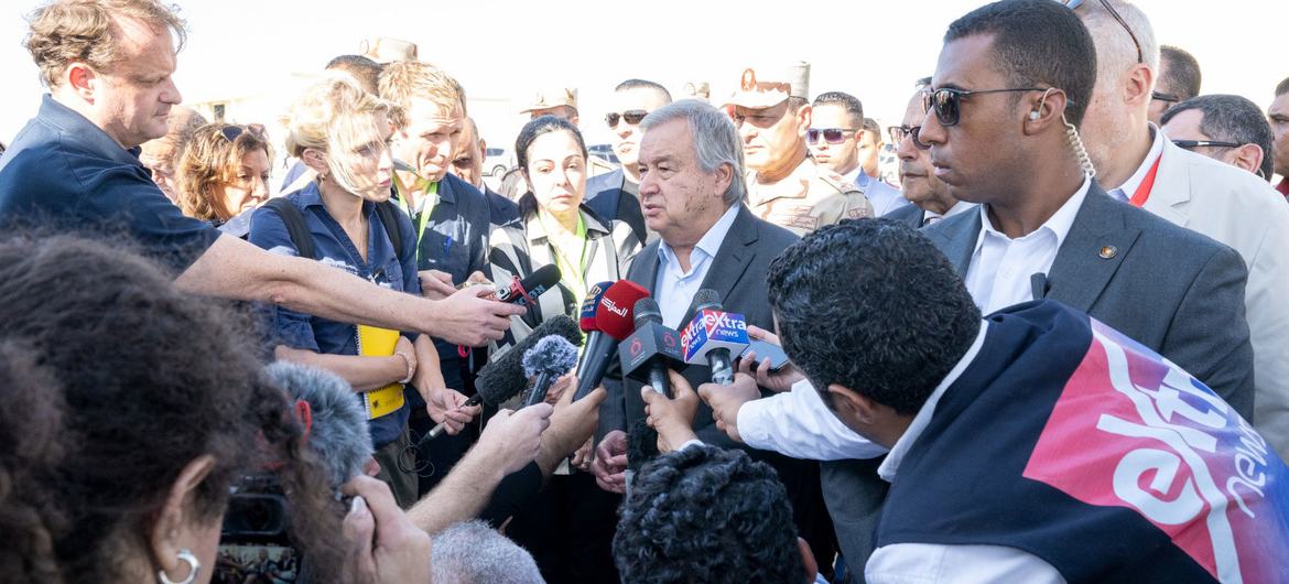 UN Secretary-General António Guterres (centre) answers questions from the media at the Rafah crossing. UN Secretary-General António Guterres (centre) answers questions from the media at the Rafah crossing.
