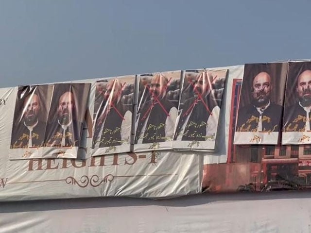 Posters against PTI supported candidate Taimur Jhagra are displayed