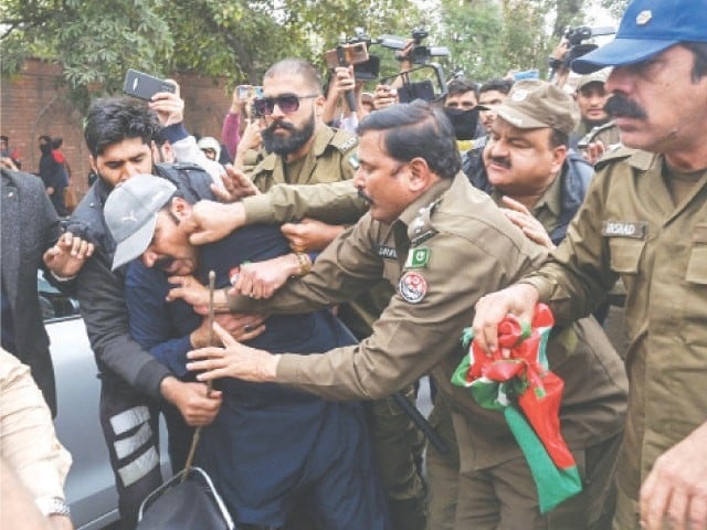 Court order to release 42 PTI workers arrested yesterday from Lahore Police officers arresting a PTI activist during a protest at GPO Chowk (Photo AFP)