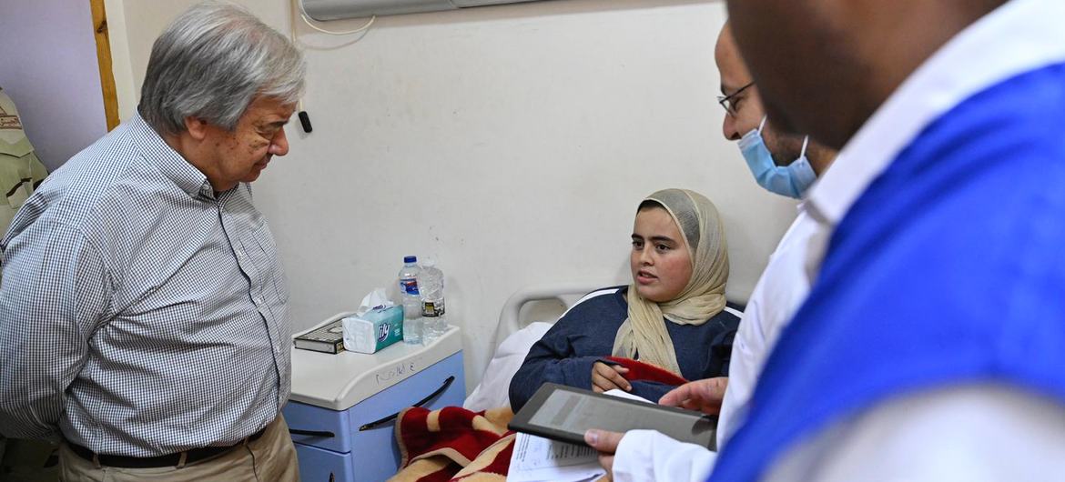 UN Secretary-General António Guterres (left) meets a Palestinian patient at a hospital in El Arish in Egypt.