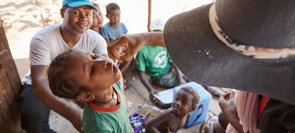 A child receives a dose of polio vaccine in Madagascar. A child receives a dose of polio vaccine in Madagascar.