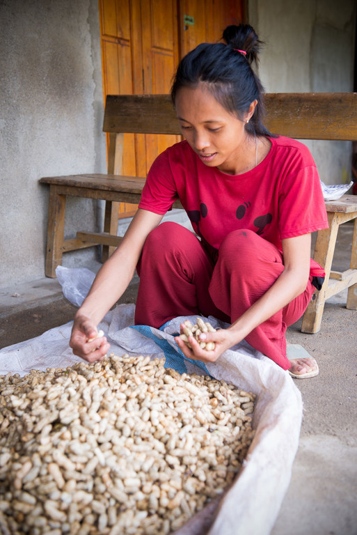 Kornelia Icha sorts through peanuts she has grown on her land.